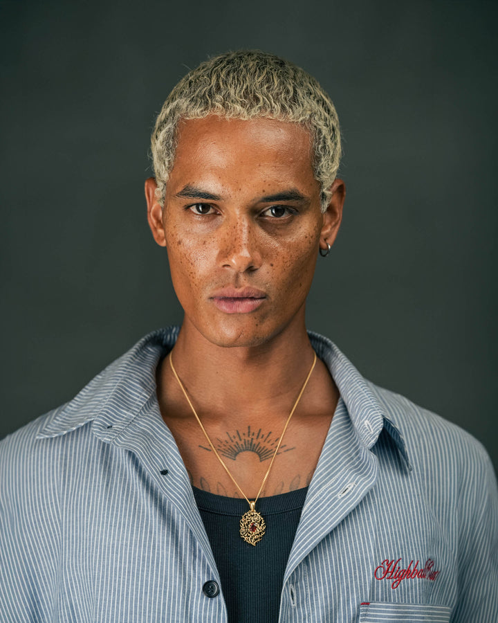 blood rose thorn pendant in gold model photograph